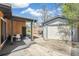Backyard featuring a covered patio area with outdoor seating and an adjacent detached garage at 6170 Estes Ct, Arvada, CO 80004