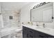 Bathroom featuring a bathtub, shower, modern double vanity with marble counters, and ample lighting at 6170 Estes Ct, Arvada, CO 80004