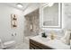 Modern bathroom with a marble shower, stylish lighting, wood vanity, and decorative art at 6170 Estes Ct, Arvada, CO 80004