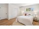 Cozy bedroom with natural light, a large closet, and light colored hardwood floors at 6170 Estes Ct, Arvada, CO 80004