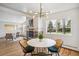 Bright dining area featuring hardwood floors, modern chandelier, and view of the fireplace at 6170 Estes Ct, Arvada, CO 80004