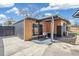 Back exterior of the home with a covered patio area, table, and chairs on a concrete slab at 6170 Estes Ct, Arvada, CO 80004