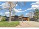 Charming single-story home featuring a black brick exterior, well-kept lawn, and covered seating area at 6170 Estes Ct, Arvada, CO 80004