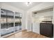 Laundry area includes a side-by-side washer/dryer and sliding glass door access to outside at 6170 Estes Ct, Arvada, CO 80004