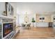Open-concept living area featuring a modern fireplace, dining space, and updated kitchen at 6170 Estes Ct, Arvada, CO 80004