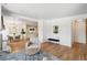 Bright living room with hardwood floors, fireplace, and view of dining area and modern kitchen at 6170 Estes Ct, Arvada, CO 80004