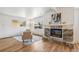 Bright living room featuring modern fireplace, hardwood floors, and ample natural light at 6170 Estes Ct, Arvada, CO 80004