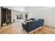 Bright living room featuring a stone fireplace, hardwood floors, and sliding glass doors to the outdoor area at 6170 Estes Ct, Arvada, CO 80004