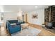 Cozy living room showcasing a comfortable blue couch, modern accents and unique fireplace at 6170 Estes Ct, Arvada, CO 80004