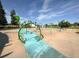 Ralston Central Park play area featuring colorful play structures and splash pad at 6170 Estes Ct, Arvada, CO 80004