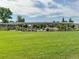 Ralston Central Park with lush green lawn, covered picnic tables, and a playground at 6170 Estes Ct, Arvada, CO 80004