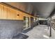 Covered patio space featuring sliding glass door and gray painted brick and light-toned wood exterior at 6170 Estes Ct, Arvada, CO 80004