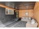 Cozy covered outdoor seating area with wood paneling, stylish rug, and comfortable wicker furniture at 6170 Estes Ct, Arvada, CO 80004