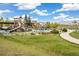 Community playground featuring a variety of structures, slides and climbing features surrounded by lush green lawns at 6170 Estes Ct, Arvada, CO 80004