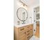 Bathroom vanity featuring a modern sink and fixtures and an open door to the bedroom at 1892 S Fairfax St, Denver, CO 80222