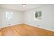 Empty bedroom featuring hardwood floors and two windows providing natural light at 1892 S Fairfax St, Denver, CO 80222