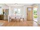 Dining area showcasing wood floors, stainless steel refrigerator, and plenty of natural light at 1892 S Fairfax St, Denver, CO 80222