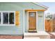 Close-up of the home's entrance featuring a solid door with glass and matching wood shutters at 1892 S Fairfax St, Denver, CO 80222