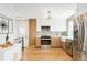 Updated kitchen featuring stainless steel appliances, quartz countertops, and sleek cabinetry at 1892 S Fairfax St, Denver, CO 80222