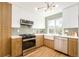 Stylish kitchen with white and wood cabinets, stainless steel appliances, and a farmhouse sink at 1892 S Fairfax St, Denver, CO 80222