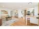 Open-concept living room with hardwood floors and a view to the kitchen and dining area at 1892 S Fairfax St, Denver, CO 80222