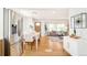 Open-concept living and dining area with stainless steel refrigerator and hardwood floors at 1892 S Fairfax St, Denver, CO 80222