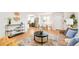 Open-concept living room with modern furniture, connecting to the dining area and updated kitchen at 1892 S Fairfax St, Denver, CO 80222