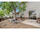 Back patio with brick accents, mature trees, and sliding glass door at 4116 W 111Th Cir, Westminster, CO 80031
