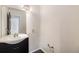 Powder room featuring a dark vanity, modern faucet, and dark laminate floors at 4116 W 111Th Cir, Westminster, CO 80031