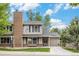 Charming two-story home showcasing a brick chimney, covered entryway, and attached one-car garage at 4116 W 111Th Cir, Westminster, CO 80031