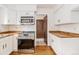 Well-lit kitchen with stainless steel appliances, butcher block countertops, and ample storage at 4116 W 111Th Cir, Westminster, CO 80031