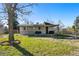 Lovely backyard with well-maintained lawn and a covered patio, perfect for outdoor enjoyment at 5390 Rosemary Ln, Denver, CO 80221