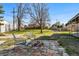 Charming backyard featuring a stone fire pit area with ample seating, ideal for outdoor gatherings and relaxation at 5390 Rosemary Ln, Denver, CO 80221