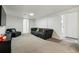 Finished basement media room with gray carpet and cozy seating at 5390 Rosemary Ln, Denver, CO 80221