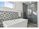 Modern bathroom with a soaking tub, sleek glass shower, and stylish tile accents at 5390 Rosemary Ln, Denver, CO 80221