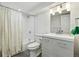 Clean bathroom with modern vanity and updated shower-tub combo at 5390 Rosemary Ln, Denver, CO 80221