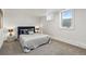 Bedroom featuring neutral walls, carpet, and a bed with a dark headboard at 5390 Rosemary Ln, Denver, CO 80221
