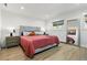 Spacious bedroom with a large bed, hardwood floors, and ample natural light at 5390 Rosemary Ln, Denver, CO 80221
