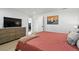 Comfortable bedroom featuring a large window, closet, and modern furniture at 5390 Rosemary Ln, Denver, CO 80221