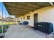 Spacious covered patio with comfortable seating and outdoor grill, ideal for relaxing and entertaining at 5390 Rosemary Ln, Denver, CO 80221