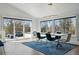 Elegant dining room with modern lighting, stylish furniture, and sliding glass doors leading to an outdoor area at 5390 Rosemary Ln, Denver, CO 80221
