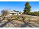 Well-maintained property showcasing a landscaped yard, two-car garage, and a distinctive architectural style at 5390 Rosemary Ln, Denver, CO 80221
