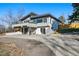 Beautifully landscaped home featuring a two-car garage, a balcony, stone accents, and a spacious driveway at 5390 Rosemary Ln, Denver, CO 80221