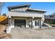 Unique home featuring stone accents, a balcony, two-car garage, and manicured landscaping adding to its curb appeal at 5390 Rosemary Ln, Denver, CO 80221