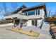 Unique home featuring stone accents, a balcony, two-car garage, and manicured landscaping adding to its curb appeal at 5390 Rosemary Ln, Denver, CO 80221