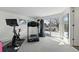 Home gym featuring exercise equipment, natural light, and a mirrored wall at 5390 Rosemary Ln, Denver, CO 80221