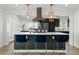 Eat in kitchen island features modern pendants, stainless steel appliances, bar seating, and bright natural light at 5390 Rosemary Ln, Denver, CO 80221