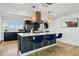 Beautiful kitchen with kitchen island, bar seating, quartz countertops, stainless steel appliances, and natural light at 5390 Rosemary Ln, Denver, CO 80221