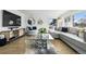 Stylish living room featuring modern decor, a comfortable seating arrangement, and a large window with natural light at 5390 Rosemary Ln, Denver, CO 80221