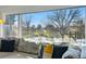 Breathtaking view from a living room window, showcasing a serene pond and lush greenery for a peaceful ambiance at 5390 Rosemary Ln, Denver, CO 80221